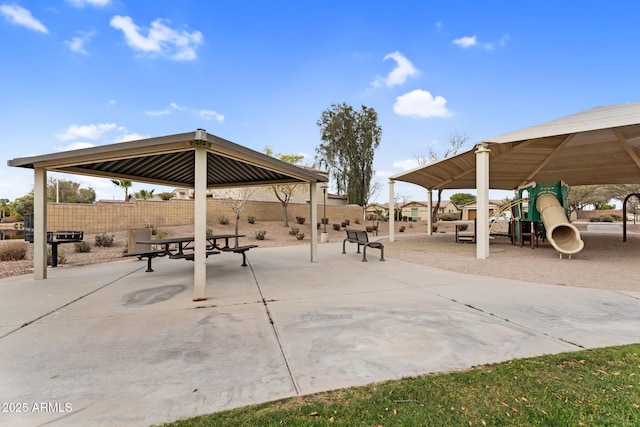 view of community with a gazebo, a patio, and fence