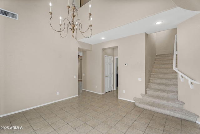 staircase with tile patterned flooring, visible vents, baseboards, recessed lighting, and a towering ceiling