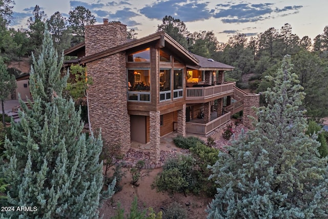 back house at dusk featuring a garage