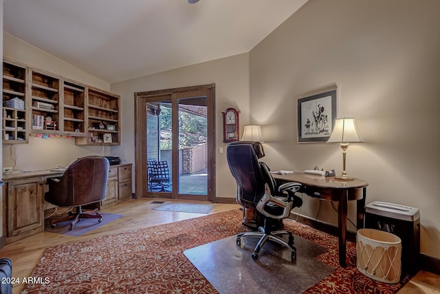 office featuring light hardwood / wood-style floors and vaulted ceiling