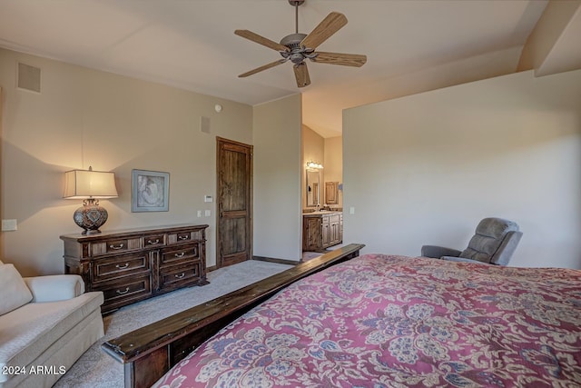 bedroom with ceiling fan, light colored carpet, and connected bathroom