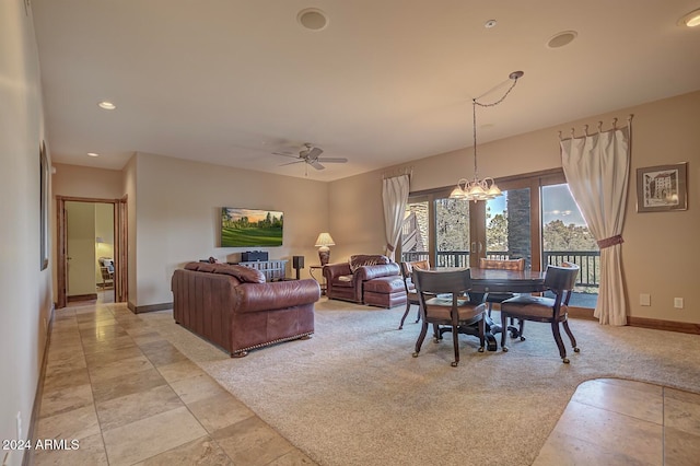 carpeted dining area with ceiling fan with notable chandelier