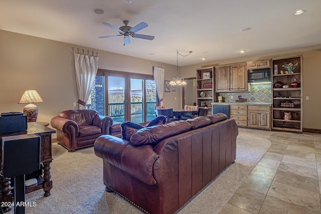 tiled living room with ceiling fan and french doors