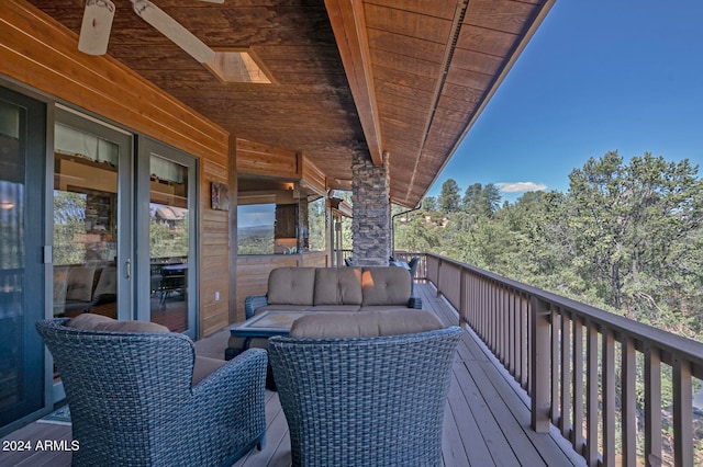 wooden terrace featuring ceiling fan