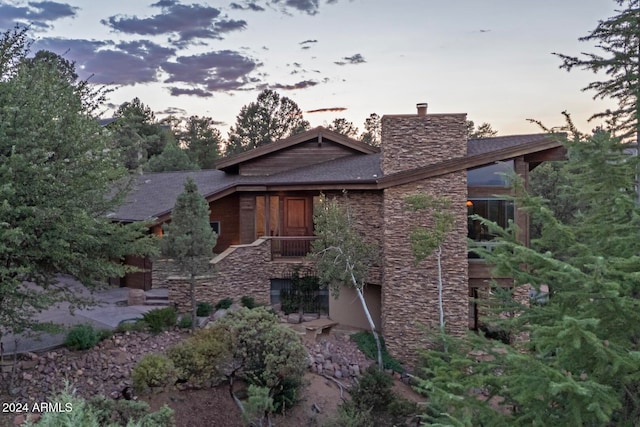 view of back house at dusk