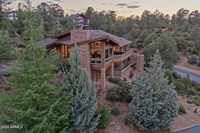 view of back house at dusk