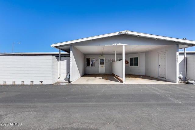 rear view of property with a carport