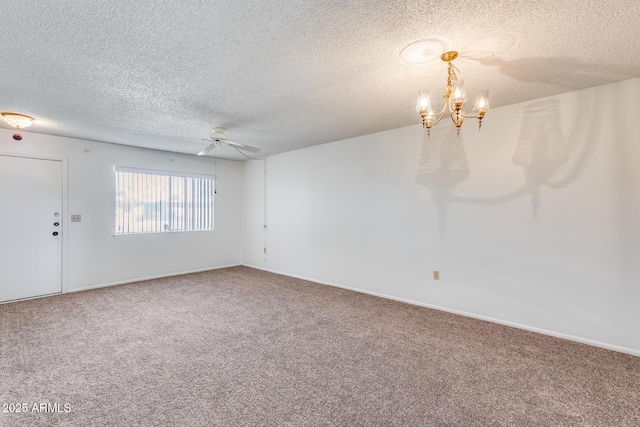 unfurnished room featuring ceiling fan with notable chandelier, a textured ceiling, and carpet flooring