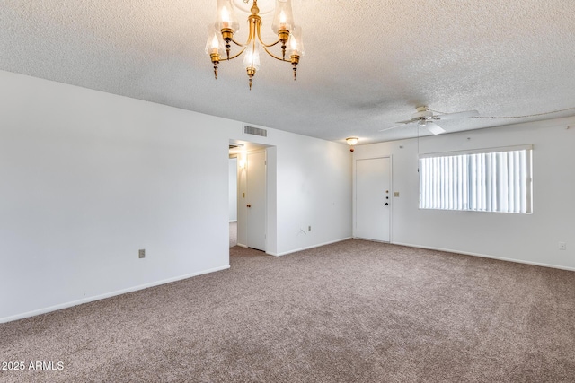 carpeted empty room with ceiling fan with notable chandelier and a textured ceiling