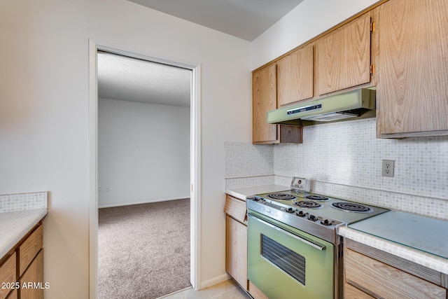 kitchen with stainless steel range with electric stovetop, light brown cabinets, light carpet, and tasteful backsplash