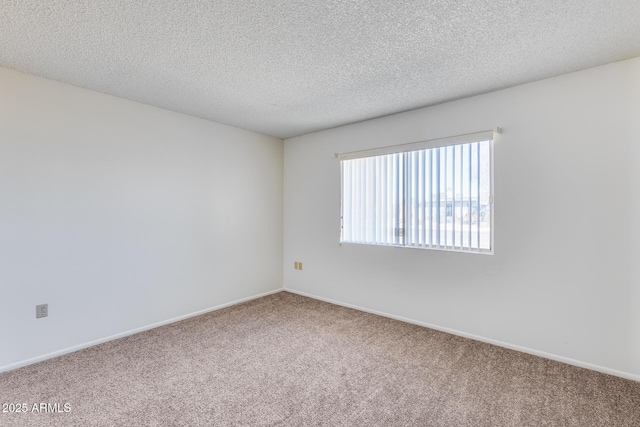 empty room featuring carpet floors and a textured ceiling