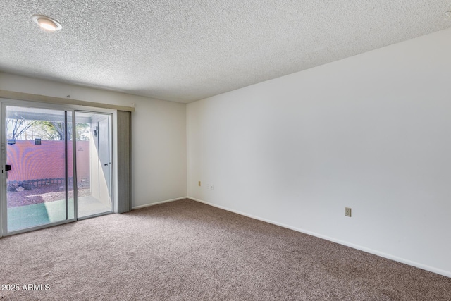 carpeted spare room with a textured ceiling