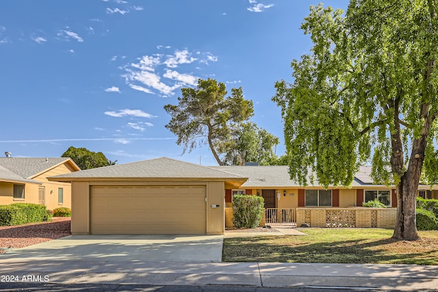 ranch-style home featuring a garage and a front yard