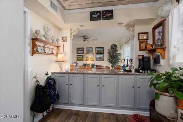 bar featuring dark hardwood / wood-style flooring, stone countertops, ceiling fan, gray cabinetry, and crown molding