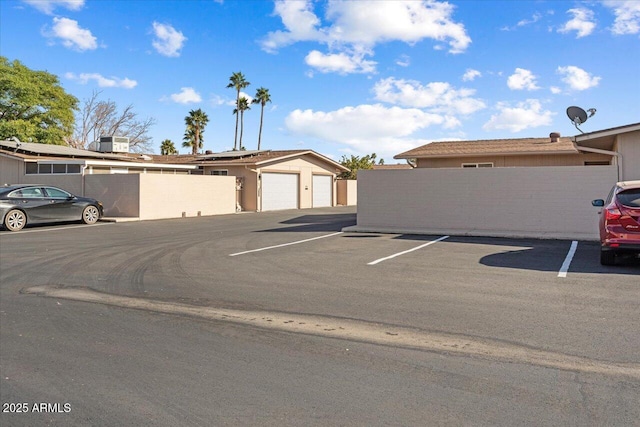 view of parking / parking lot with a garage