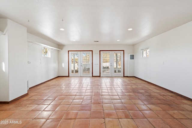 tiled empty room with french doors