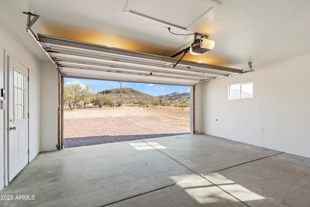 garage with a mountain view and a garage door opener