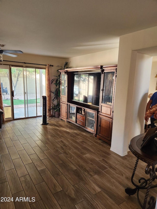 unfurnished living room with ceiling fan and wood-type flooring