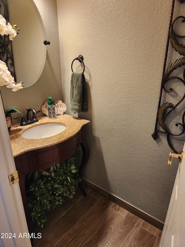 bathroom featuring vanity and hardwood / wood-style floors