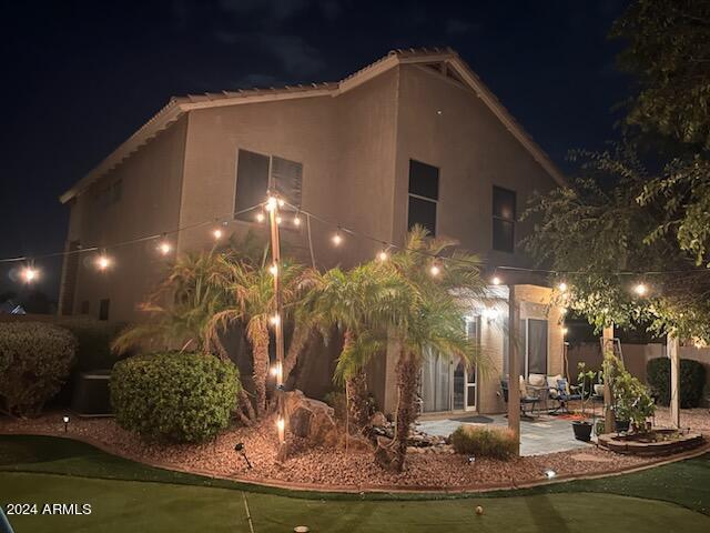 property exterior at twilight with a patio