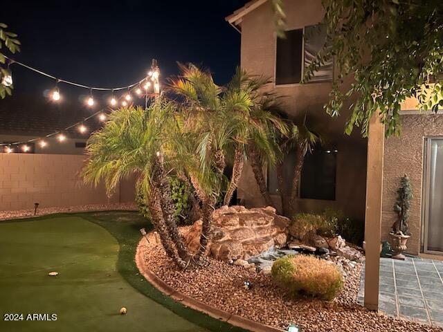 view of yard at twilight