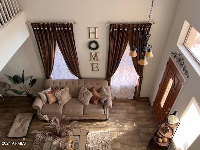 living room with dark hardwood / wood-style floors and a high ceiling