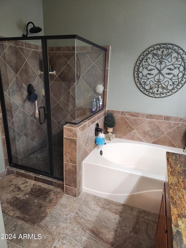 bathroom with separate shower and tub and tile patterned flooring