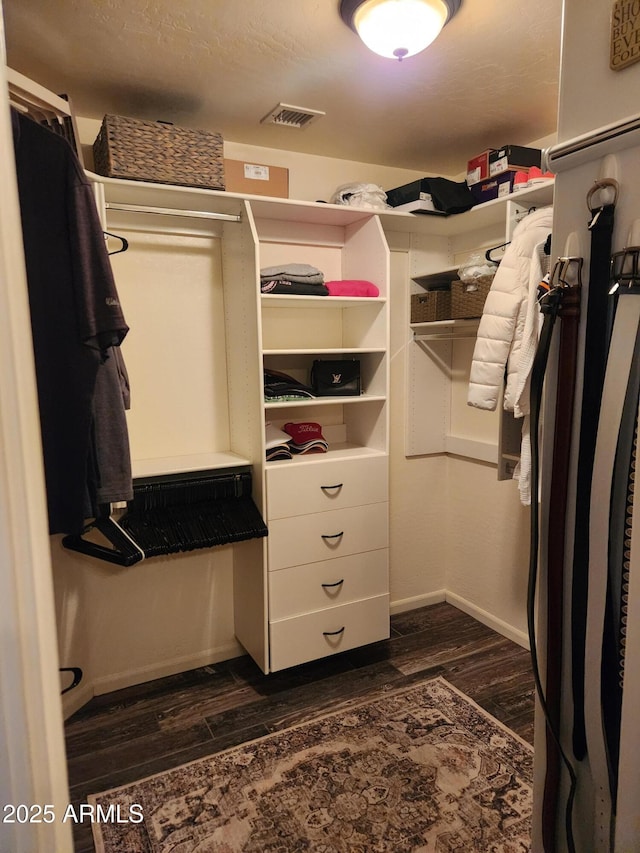 spacious closet with dark wood-type flooring