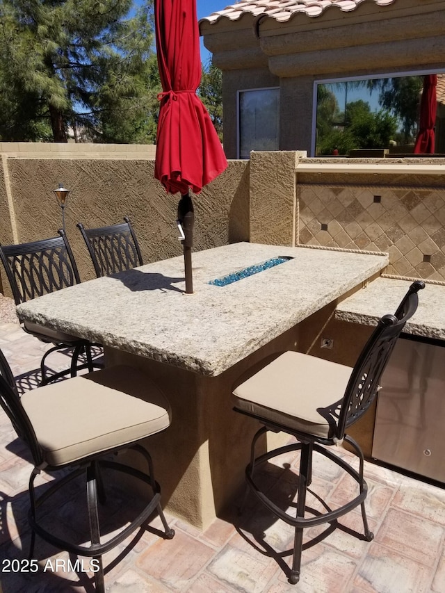 view of patio with an outdoor bar