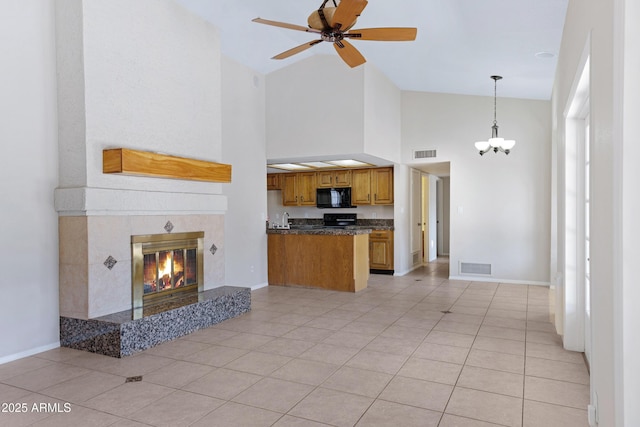 kitchen featuring dark countertops, visible vents, open floor plan, and black microwave