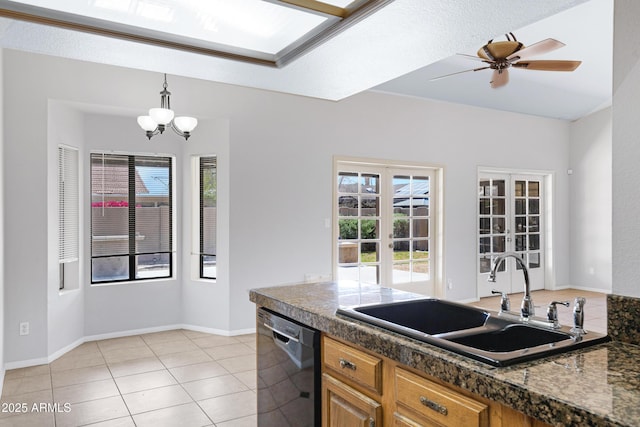 kitchen featuring tile counters, dishwasher, french doors, and a sink