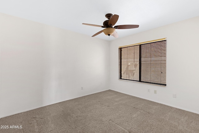 unfurnished room featuring baseboards, carpet floors, and ceiling fan