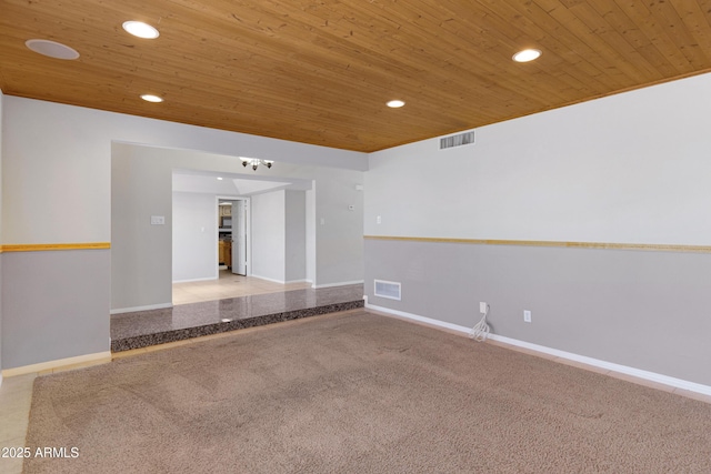 carpeted spare room with visible vents, recessed lighting, and wood ceiling