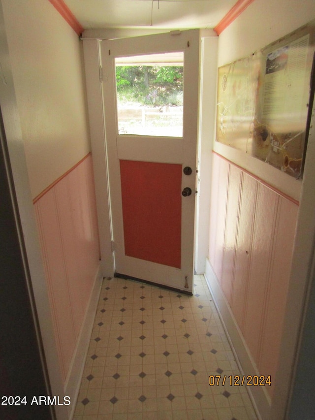 60 Wood Cyn, Bisbee, AZ 85603 - doorway with a wainscoted wall, ornamental molding, a decorative wall, and light floors