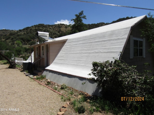 60 Wood Cyn, Bisbee, AZ 85603 - view of side of property with a gambrel roof and central AC unit