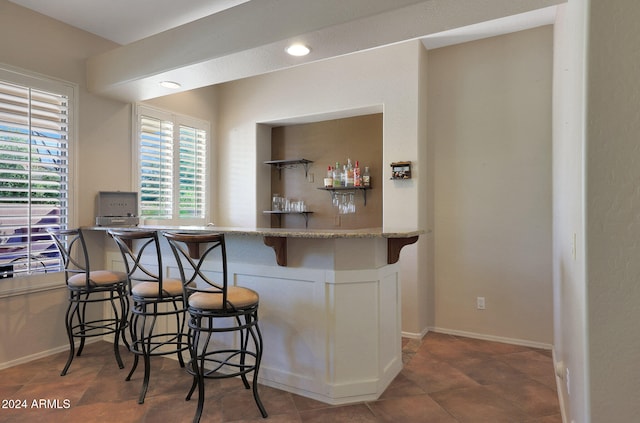 bar featuring dark tile patterned flooring