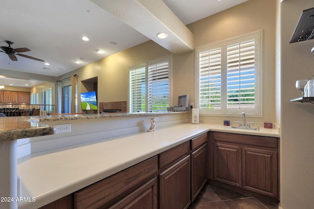 kitchen with a sink, light countertops, ceiling fan, and recessed lighting