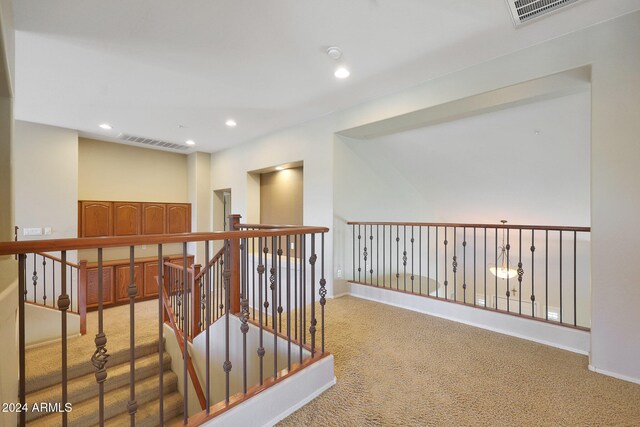 hallway featuring light colored carpet