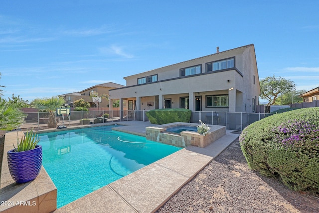 view of swimming pool featuring a patio area and an in ground hot tub