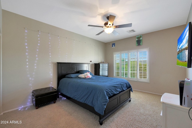 bedroom featuring baseboards, ceiling fan, light carpet, and visible vents