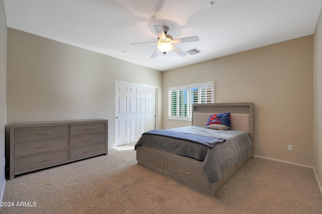 carpeted bedroom with a ceiling fan, baseboards, visible vents, and a closet