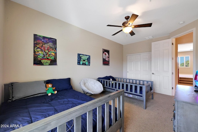 carpeted bedroom with visible vents and ceiling fan