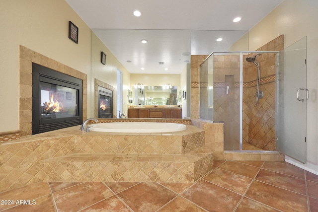 bathroom featuring tile patterned flooring, a bath, a stall shower, and recessed lighting