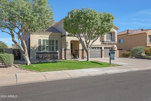 view of front of home featuring a garage and a front lawn