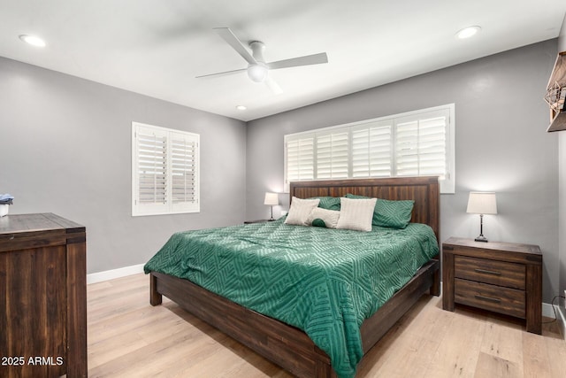 bedroom featuring multiple windows, ceiling fan, and light hardwood / wood-style flooring