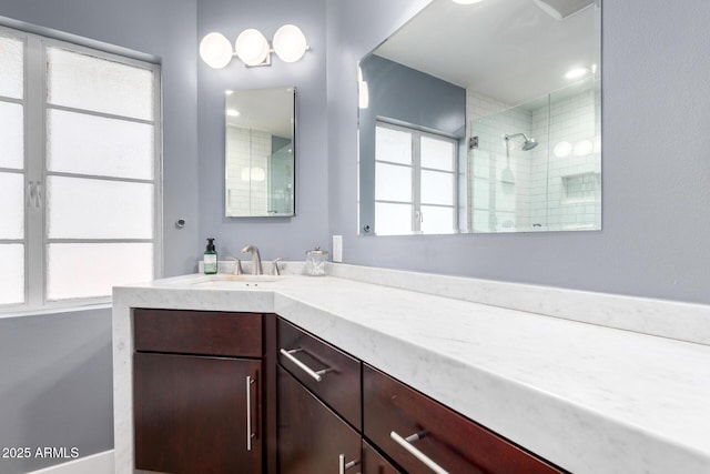 bathroom featuring vanity and a tile shower