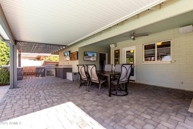 view of patio with area for grilling and ceiling fan