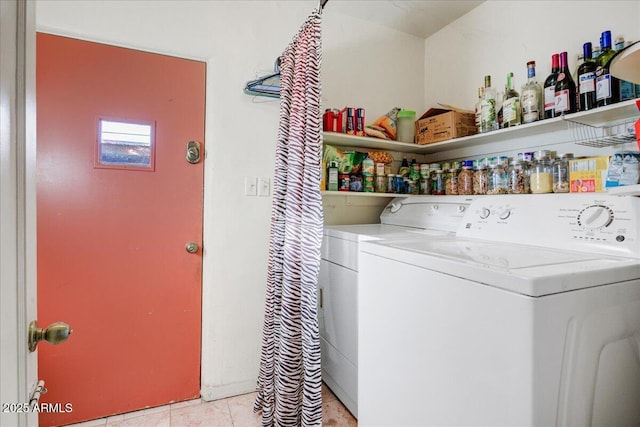 clothes washing area with light tile patterned flooring, laundry area, and independent washer and dryer