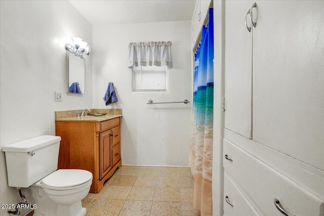 bathroom featuring toilet and vanity