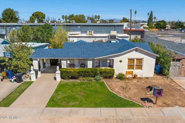 ranch-style house with stucco siding and a front lawn